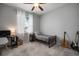 Neutral bedroom with gray carpet, twin bed, ceiling fan, and desk by bright window at 424 Bahama Grande Blvd, Apollo Beach, FL 33572