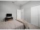 Neutral bedroom with gray carpet, twin bed, black desk, and closet at 424 Bahama Grande Blvd, Apollo Beach, FL 33572