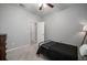 Bedroom with a ceiling fan, gray walls, and a black metal bed frame and soft carpet at 424 Bahama Grande Blvd, Apollo Beach, FL 33572