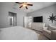 Bright bedroom features neutral walls, soft carpet, ceiling fan, and a white dresser with a TV at 424 Bahama Grande Blvd, Apollo Beach, FL 33572