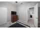 Bedroom featuring a ceiling fan, gray walls, wood dresser with a TV, and soft carpet at 424 Bahama Grande Blvd, Apollo Beach, FL 33572