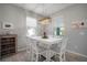 Bright dining area with a modern light fixture and cozy decor, with an outdoor view at 424 Bahama Grande Blvd, Apollo Beach, FL 33572