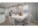 Modern dining area with white table, chandelier, and kitchen views at 424 Bahama Grande Blvd, Apollo Beach, FL 33572