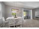 Dining area featuring a modern light fixture and access to the outdoor patio at 424 Bahama Grande Blvd, Apollo Beach, FL 33572