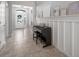 Inviting foyer with elegant wainscoting, tile flooring, and a stylish front door that lets in natural light at 424 Bahama Grande Blvd, Apollo Beach, FL 33572