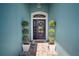 Charming home entryway with decorative door, lovely potted plants, welcome mat, and elegant finishes at 424 Bahama Grande Blvd, Apollo Beach, FL 33572