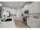 Clean kitchen featuring white cabinets, stainless appliances and stone countertops at 424 Bahama Grande Blvd, Apollo Beach, FL 33572