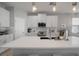 Modern kitchen featuring white cabinets, a stainless steel microwave, and a large island with a white countertop at 424 Bahama Grande Blvd, Apollo Beach, FL 33572