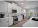 Well-equipped kitchen featuring white cabinets, stainless steel appliances, and a breakfast bar at 424 Bahama Grande Blvd, Apollo Beach, FL 33572