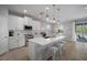Open kitchen with a large island, pendant lighting, and stainless steel appliances at 424 Bahama Grande Blvd, Apollo Beach, FL 33572
