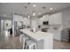 Bright, spacious kitchen with stainless steel appliances, white cabinetry, and a large center island with seating at 424 Bahama Grande Blvd, Apollo Beach, FL 33572