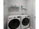 Bright laundry room featuring new front loading washer and dryer at 424 Bahama Grande Blvd, Apollo Beach, FL 33572