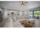 Open-concept living area flowing into the kitchen, featuring a large sectional and modern finishes at 424 Bahama Grande Blvd, Apollo Beach, FL 33572