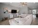 Cozy living room with neutral walls, large sectional sofa, and a stylish entertainment center at 424 Bahama Grande Blvd, Apollo Beach, FL 33572