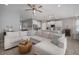 Bright living room open to the kitchen featuring neutral tones, a ceiling fan, and contemporary decor at 424 Bahama Grande Blvd, Apollo Beach, FL 33572