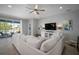 Comfortable living room with large sectional, ceiling fan, and access to an outdoor patio at 424 Bahama Grande Blvd, Apollo Beach, FL 33572