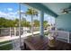 Screened patio with seating area overlooking the beautiful backyard with landscaping at 424 Bahama Grande Blvd, Apollo Beach, FL 33572
