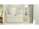 Elegant bathroom with white vanity and sink, framed mirror and natural lighting from the window at 4807 Southern Valley Loop, Brooksville, FL 34601