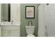Cozy bathroom featuring a toilet with an art print, a vanity, and a bathtub with a shower curtain at 4807 Southern Valley Loop, Brooksville, FL 34601