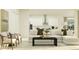 Open-concept living room with stylish seating, a modern kitchen view, and lots of natural light at 4807 Southern Valley Loop, Brooksville, FL 34601