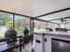 The outdoor kitchen features a pizza oven, stainless steel grill, and bar seating, perfect for entertaining at 504 Hilldale Rd, Brandon, FL 33510