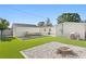 Expansive backyard with patio seating, artificial grass, landscaping, and backyard games at 5298 Oxford N Ave, St Petersburg, FL 33710