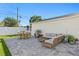 Cozy backyard with a paved patio, stylish outdoor furniture, string lights, and landscaping at 5298 Oxford N Ave, St Petersburg, FL 33710