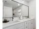 Modern bathroom features double sink vanity, large mirror, and tile backsplash at 5298 Oxford N Ave, St Petersburg, FL 33710