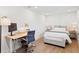 Bright bedroom includes a desk, workspace, and comfortable seating area at 5298 Oxford N Ave, St Petersburg, FL 33710