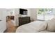 Sunlit bedroom boasts hardwood floors, large dresser, and access to living area at 5298 Oxford N Ave, St Petersburg, FL 33710