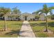 Charming single-story home with lush lawn, landscaped yard, and inviting pathway at 5298 Oxford N Ave, St Petersburg, FL 33710