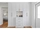 Bright hallway features built-in storage cabinets, drawers and bar area at 5298 Oxford N Ave, St Petersburg, FL 33710