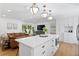 Modern kitchen with white cabinets, a large island, stainless steel appliances, open concept at 5298 Oxford N Ave, St Petersburg, FL 33710