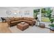Cozy living room featuring a comfortable leather sectional, and a large window at 5298 Oxford N Ave, St Petersburg, FL 33710
