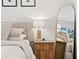 Plush main bedroom features a nightstand, table lamp and large mirror at 5298 Oxford N Ave, St Petersburg, FL 33710