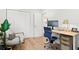 Bright home office featuring hardwood floors, a modern desk setup, and a comfortable sitting chair at 5298 Oxford N Ave, St Petersburg, FL 33710