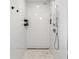 Bright shower features tile surround, shower head and built-in shelving at 5298 Oxford N Ave, St Petersburg, FL 33710