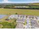 Aerial view showcases new townhome community, playground, parking area and lush field with grazing cows at 5429 Companion Ln, Tampa, FL 33619