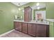 Bathroom with a dual sink vanity, modern fixtures, and a medicine cabinet between the two sinks at 5429 Companion Ln, Tampa, FL 33619