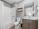 Bathroom featuring a shower-tub combo, light gray paint, wooden shelves and a modern vanity at 5429 Companion Ln, Tampa, FL 33619