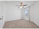 An empty bedroom with carpet, a ceiling fan, and a large window overlooking the outdoors at 5429 Companion Ln, Tampa, FL 33619