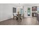 Cozy dining nook bathed in natural light, featuring a modern chandelier, and access to the outdoor area at 5429 Companion Ln, Tampa, FL 33619