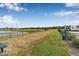 Community dog park featuring fenced open space with a view of a pond and a few trees at 5429 Companion Ln, Tampa, FL 33619