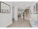 Bright entryway featuring wood floors, stairs, and views of the dining and living areas, for a seamless transition at 5429 Companion Ln, Tampa, FL 33619