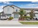 Charming townhome showcasing a well-manicured lawn and a two-car garage, nestled in a desirable neighborhood at 5429 Companion Ln, Tampa, FL 33619