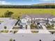Modern townhome exterior view with driveways, manicured landscaping and expansive green space beyond at 5429 Companion Ln, Tampa, FL 33619