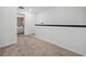 Upstairs hallway featuring neutral carpet and view into the main bedroom at 5429 Companion Ln, Tampa, FL 33619