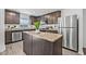 Well-equipped kitchen with stainless steel appliances, a central island, and ample counter space for cooking at 5429 Companion Ln, Tampa, FL 33619