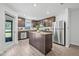 Modern kitchen features stainless steel appliances, granite countertops, and a central island at 5429 Companion Ln, Tampa, FL 33619