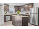 Modern kitchen with stainless steel appliances, granite countertops, and a functional island, perfect for culinary creations at 5429 Companion Ln, Tampa, FL 33619
